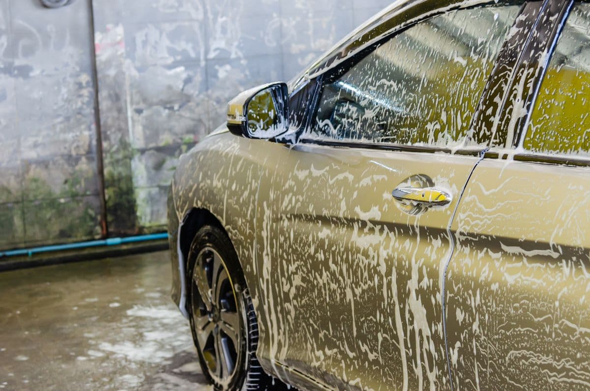 A car covered in soap suds during an exterior hand wash