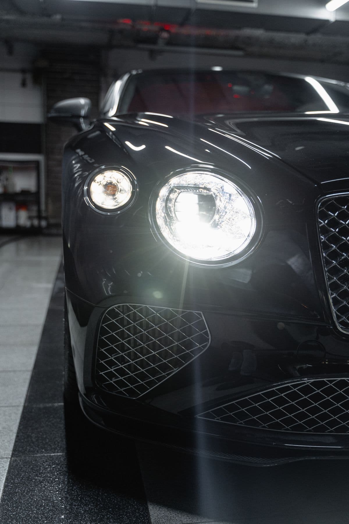A freshly detailed car gleaming under the shop lights